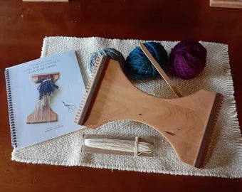 hand-crafted small hand held wooden weaving loom with book and additional tools and accessories.